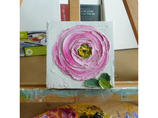 pink ranunculus  painting on a easel