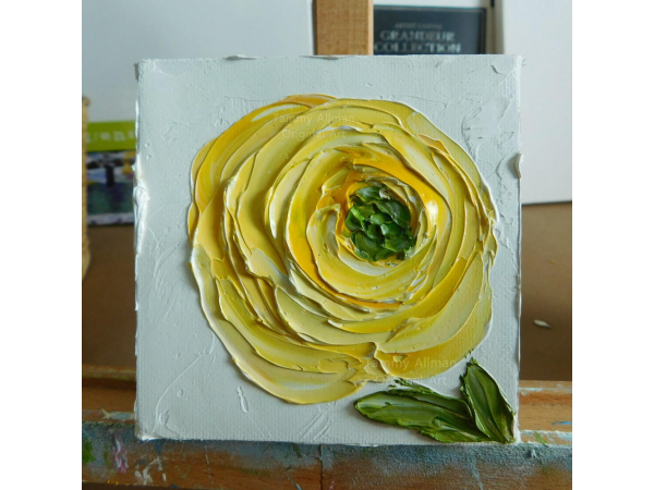 yellow ranunculus oil painting on a easel